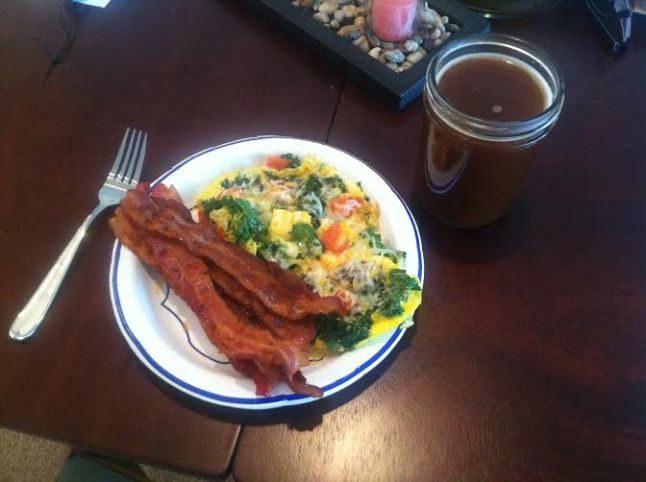 Freshly picked kale and tomatoes from my garden in a veggie/cheese omelet, bacon, and coffee with coconut milk (no sugar added)! #nomnom